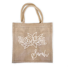 Load image into Gallery viewer, Burlap tote bag with a floral design personalized with your name.
