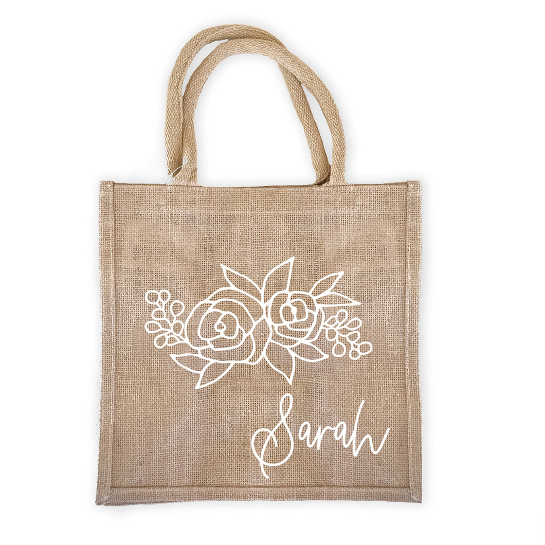 Burlap tote bag with a floral design personalized with your name.