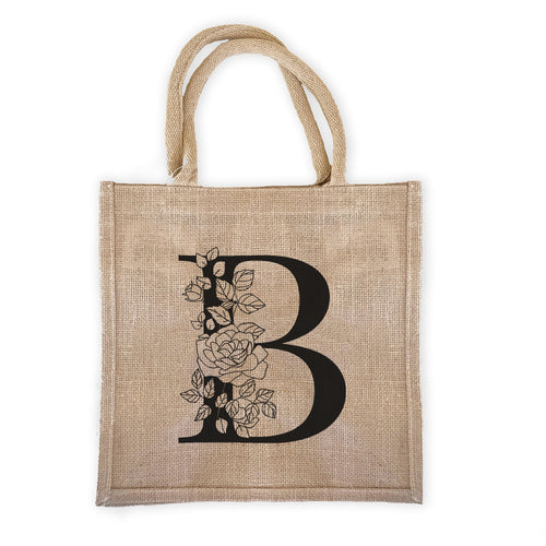 burlap bag with a monogram that has floral detail.