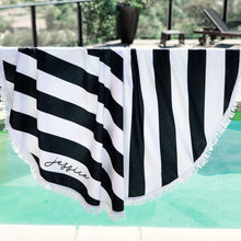 Load image into Gallery viewer, Black and white striped round towel hanging. Personalized name shown on the bottom. Fringe on the ends.
