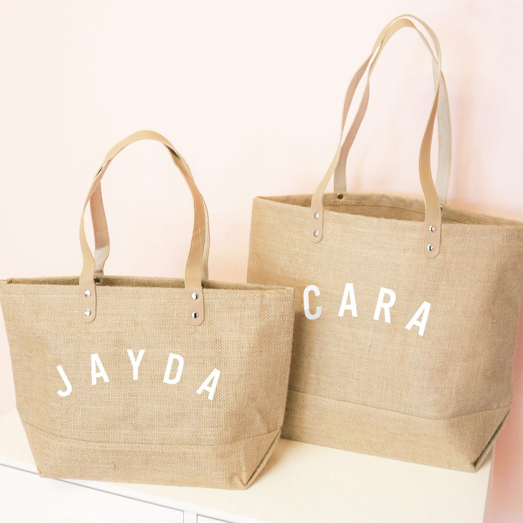 Large and small jute bag with curved text on one side