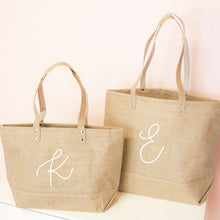 Load image into Gallery viewer, jute bags shown with a monogramed letter on one side

