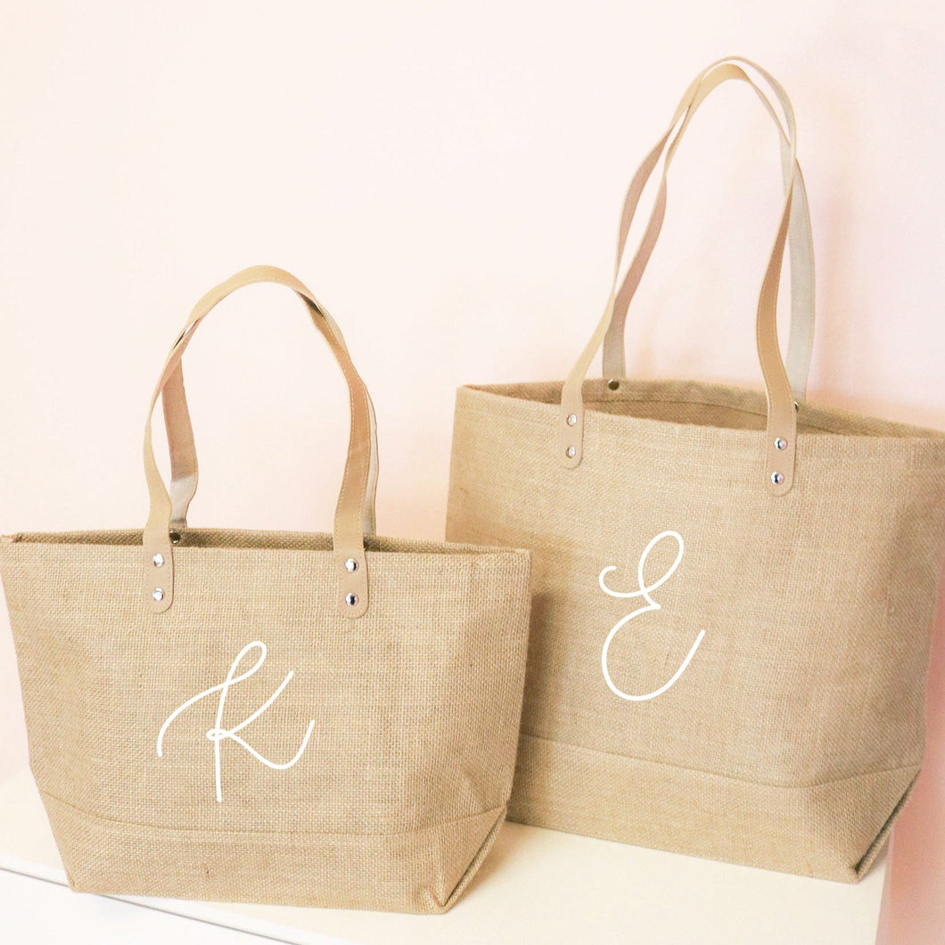 jute bags shown with a monogramed letter on one side